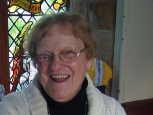 woman welcoming people to church