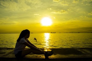 woman by ocean sunset