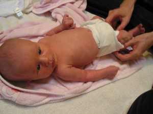 newborn being diapered