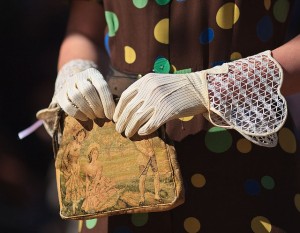 womans hands in gloves with handbag