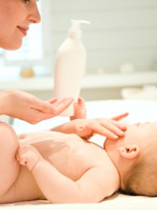putting lotion on baby