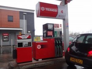 gas station pumps and trash cans