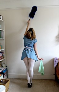 woman dusting wall