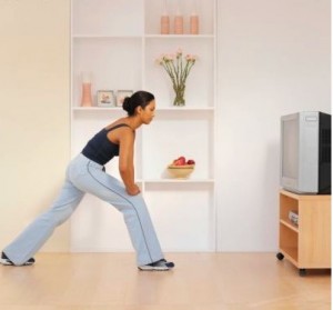 woman exercising in front of television