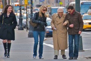 couple helping old man
