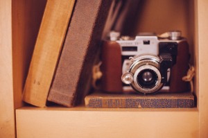 antique camera on bookshelf
