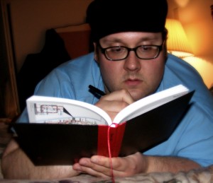 man with glasses journaling