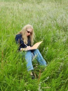 woman journaling in field