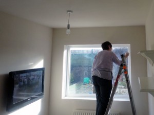 painting a wall in a bedroom