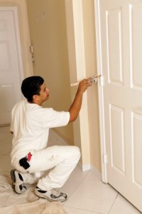 man painting interior door